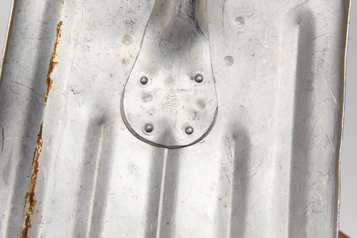 Close-up of a shovel with visible branding marking.