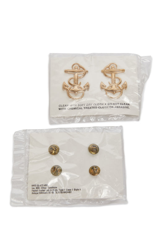 Gold anchor insignia in packaging on a white background