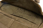 Close-up of a brown bag with 'K.M.A.' and dates markings