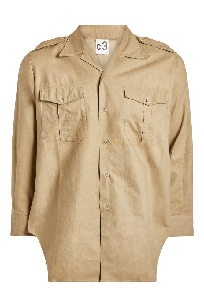 Beige shirt with two front pockets on a white background