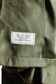 Close-up of a green shirt with a label on the interior.