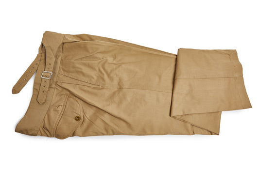 Folded khaki pants on a white background