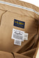 Close-up of khaki pants with U.S. Navy branded labels 