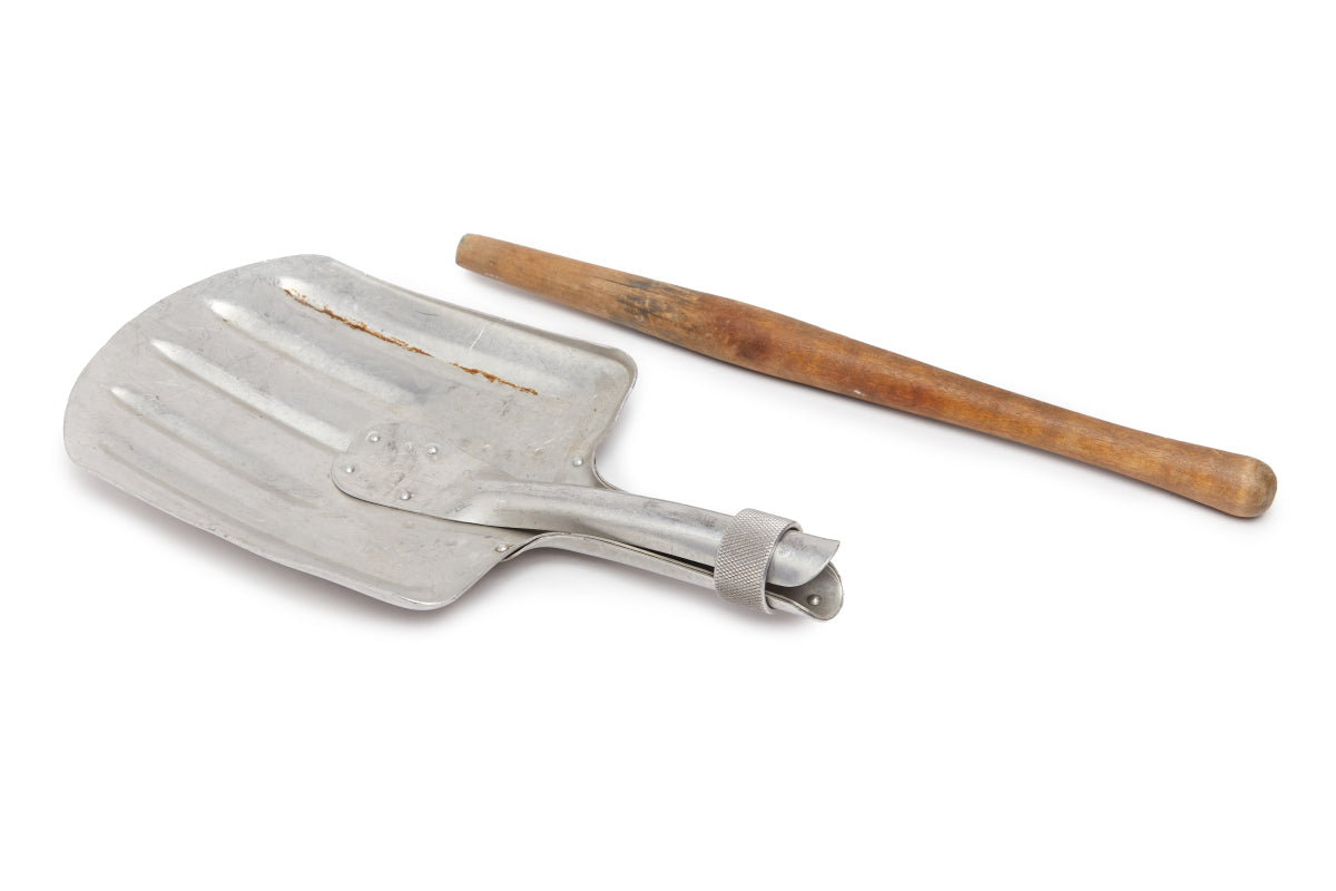 Metal shovel with wooden handle on a white background