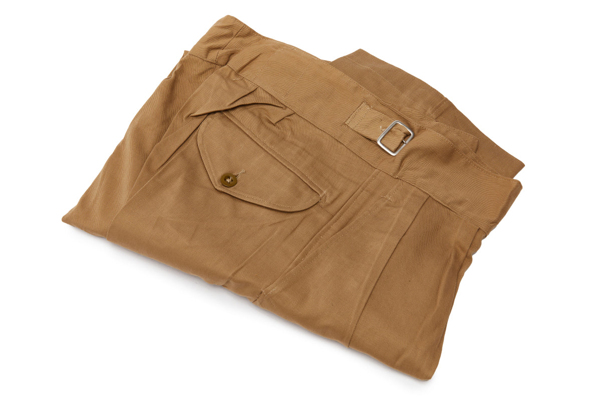 Folded brown pants on a white background