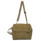 Green canvas messenger bag with a strap on a white background