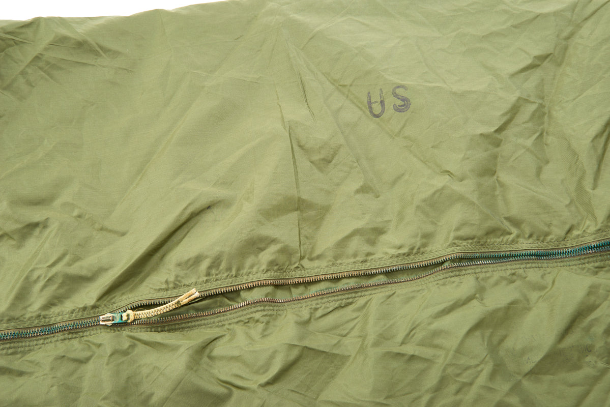 Green military-style bag with 'US' marking